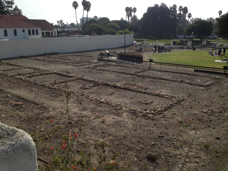 Original foundations of the Mission Buildings. The "new" mission is just beyond the wall.